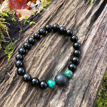 Load image into Gallery viewer, Lava Stone Focal Bracelet with African Turquoise This bracelet is made with a Lava stone focal bead, African Turquoise, and Rainbow Obsidian. These stones together bring light to the most blocked and stagnant energy and give the wearer strength to pursue
