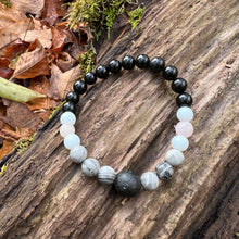 Load image into Gallery viewer, Lava Stone Focal Bracelet with Rainbow Obsidian This bracelet is made with a Lava stone focal bead, Gray Map Jasper, White Jade, Pink Morganite, and Rainbow Obsidian. Together these stones bring the wearer a sense of relaxation, and a release of stagnant
