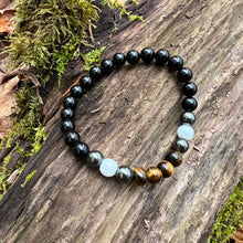 Load image into Gallery viewer, Triple Protection Obsidian, Tiger Eye, and Hematite Bracelet This bracelet is made with Black Obsidian, Tiger Eye, and Hematite. These stones together brings the wearer protection against negative energy of all kinds- inner, spiritual, and environmental.
