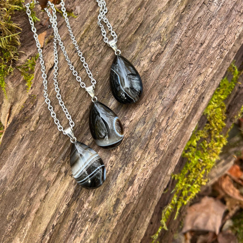 Tuxedo Agate Teardrop Necklace This necklace is made with a high-quality Tuxedo Agate stone which brings stability and release to the wearer. Zodiac: Gemini & Virgo Chakras: Third Eye, Root, Crown & Heart. Handmade with authentic crystals and gemstones.