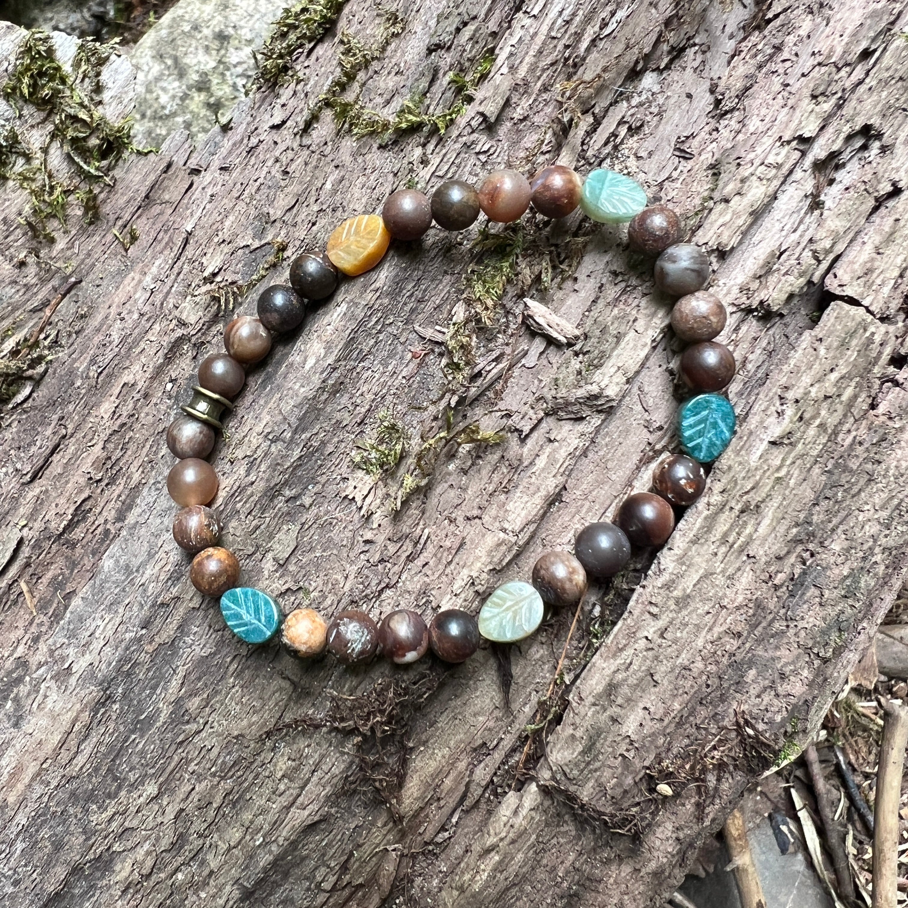 Bracelet with brown and agate beads on a wooden surface