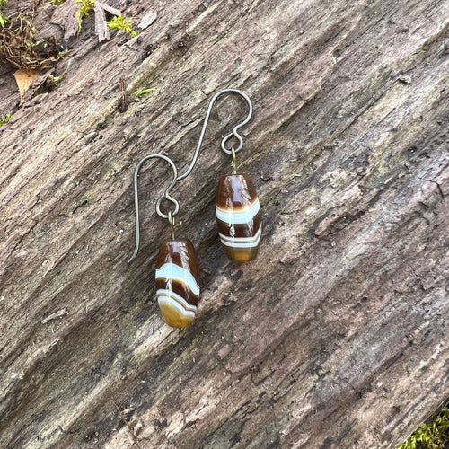 Tibetan Agate Earrings These earrings are made with authentic Tibetan Agate gemstones, which is believed to bestow its wearer with a sense of balance and protection, shielding you from negative energies while enhancing your inner strength and resilience.