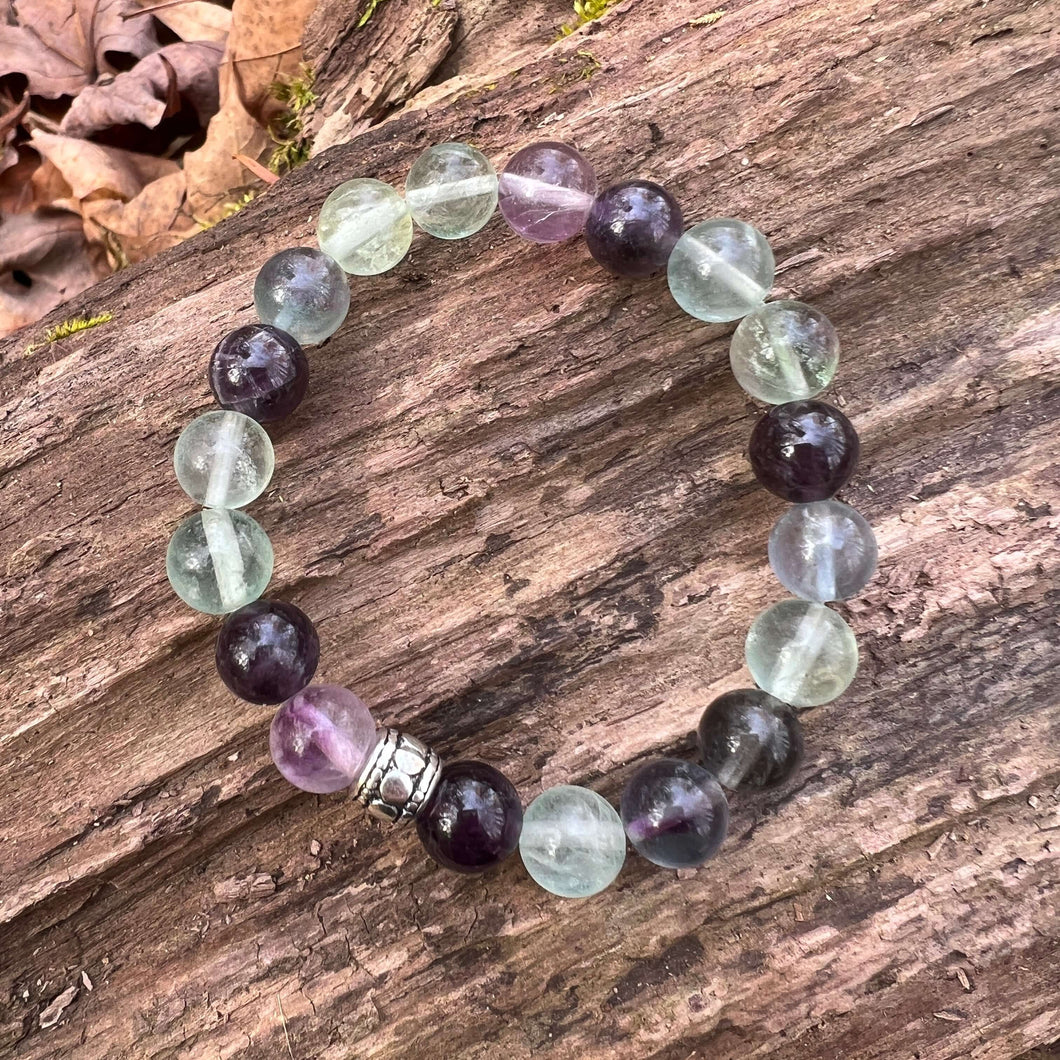 Fluorite and Amethyst Bead Bracelet This bracelet is made with high-quality Fluorite and Amethyst stones which bring stability, protection and awareness to the wearer. Zodiac Sign: Capricorn. Chakra: Heart. Handmade with authentic crystals and gemstones i