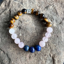Load image into Gallery viewer, Taurus Zodiac Bracelet The Taurus Zodiac Bracelet is created with a combination of Rose Quartz, Lapis Lazuli, and Tiger Eye beads which resonate with the grounded and sensual qualities associated with this zodiac sign.
