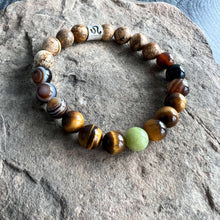 Load image into Gallery viewer, Leo Zodiac Bracelet The Leo Zodiac Bracelet is created with a combination of Peridot, Tiger Eye, and Picture Jasper beads which resonate with the bold and charismatic qualities associated with this zodiac sign.
