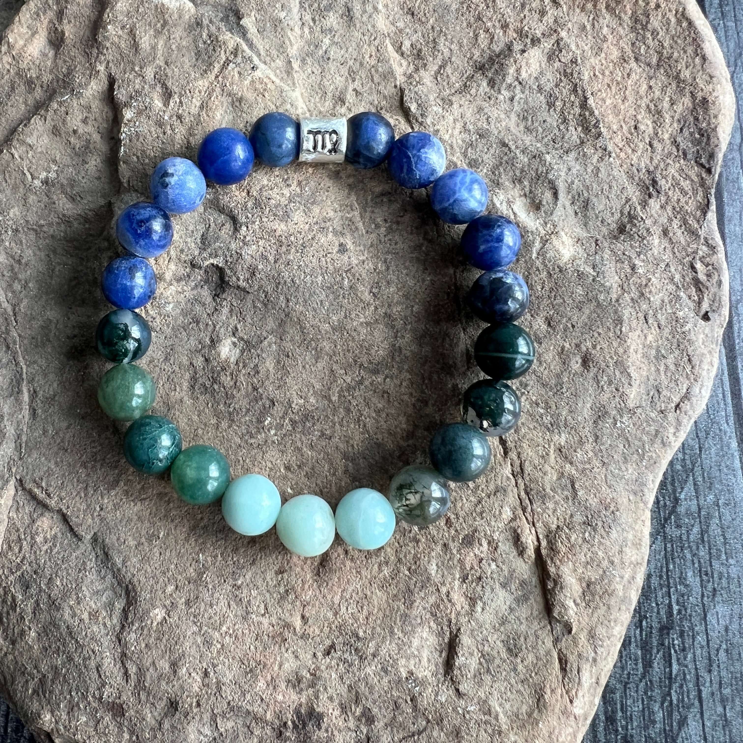 Virgo Zodiac Bracelet The Virgo Zodiac Bracelet is created with a combination of Moss Agate, Amazonite, and Sodalite beads which resonate with the practical and analytical qualities associated with this zodiac sign.