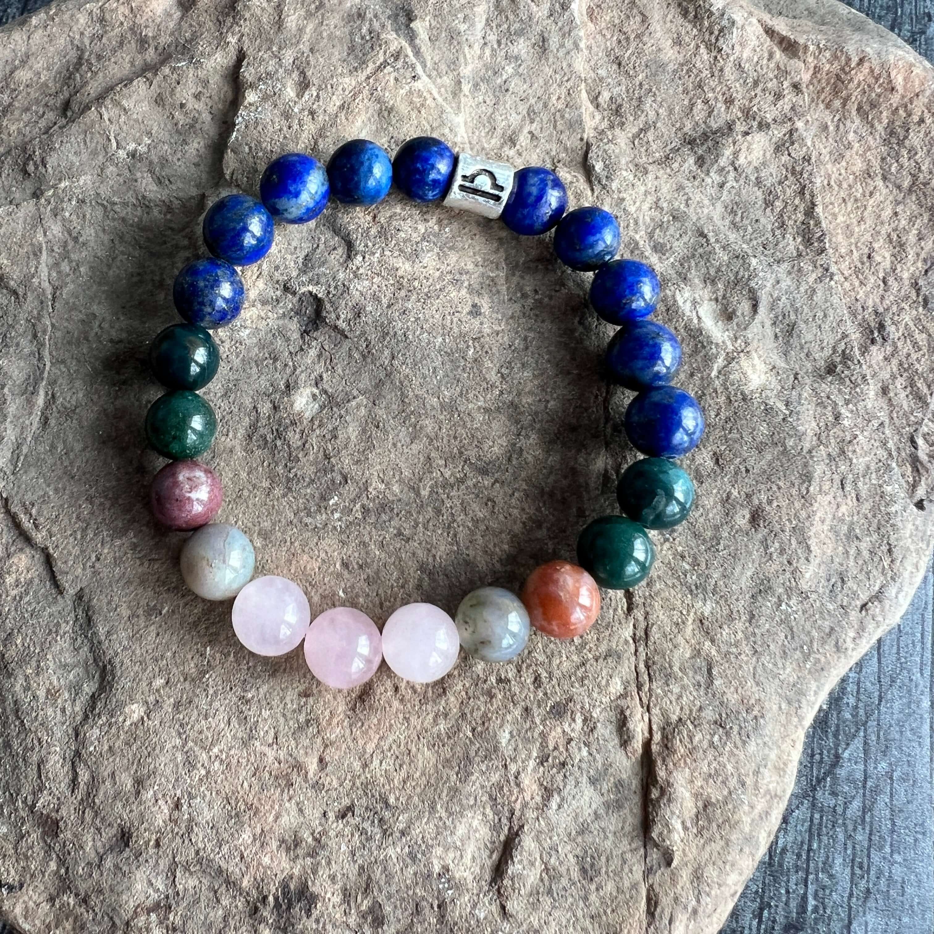 Libra Zodiac Bracelet The Libra Zodiac Bracelet is created with a combination of Rose Quartz, Agate and Lapis beads, which resonate with the graceful and harmonious qualities associated with this zodiac sign.