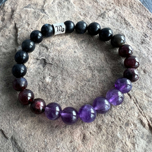 Scorpio Zodiac Bracelet The Scorpio Zodiac Bracelet is created with a combination of Amethyst, Garnet, and Black Obsidian beads which resonate with the qualities associated with with the intense and transformative qualities associated with this zodiac sig