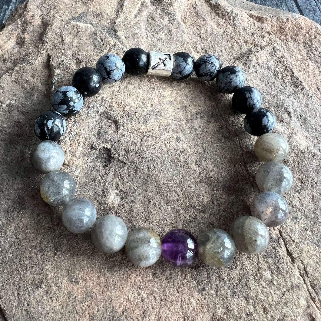 Sagittarius Zodiac Bracelet The Sagittarius Zodiac Bracelet is created with a combination of Amethyst, Labradorite, and Snowflake Obsidian beads which resonate with the the expansive and adventurous qualities of this zodiac sign.