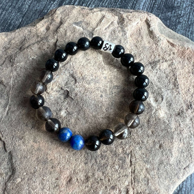 Capricorn Zodiac Bracelet The Capricorn Zodiac Bracelet is created with a combination of Lapis Lazuli, Smoky Quartz, and Onyx beads, which resonate with the strong and determined qualities associated with this zodiac sign.