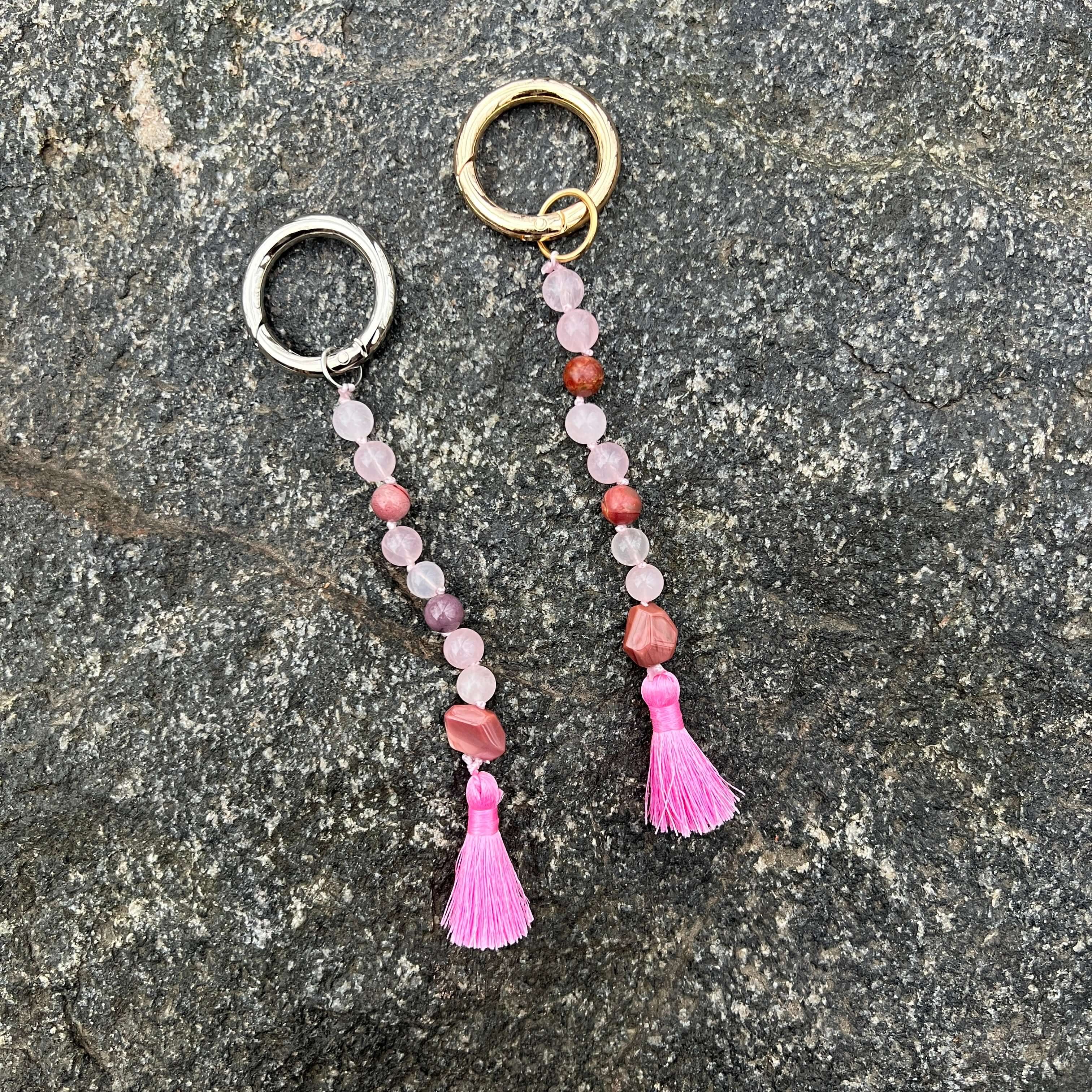 Keychain with beads and tassels on a stone surface