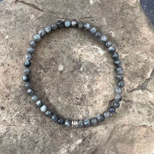 Larvikite Bracelet This bracelet is made with high-quality Larvikite stones which bring protection and a strong connection to nature to the wearer. Zodiac Signs: Aquarius. Chakras: Root and Third Eye. Handmade with authentic crystals & gemstones in Minnea