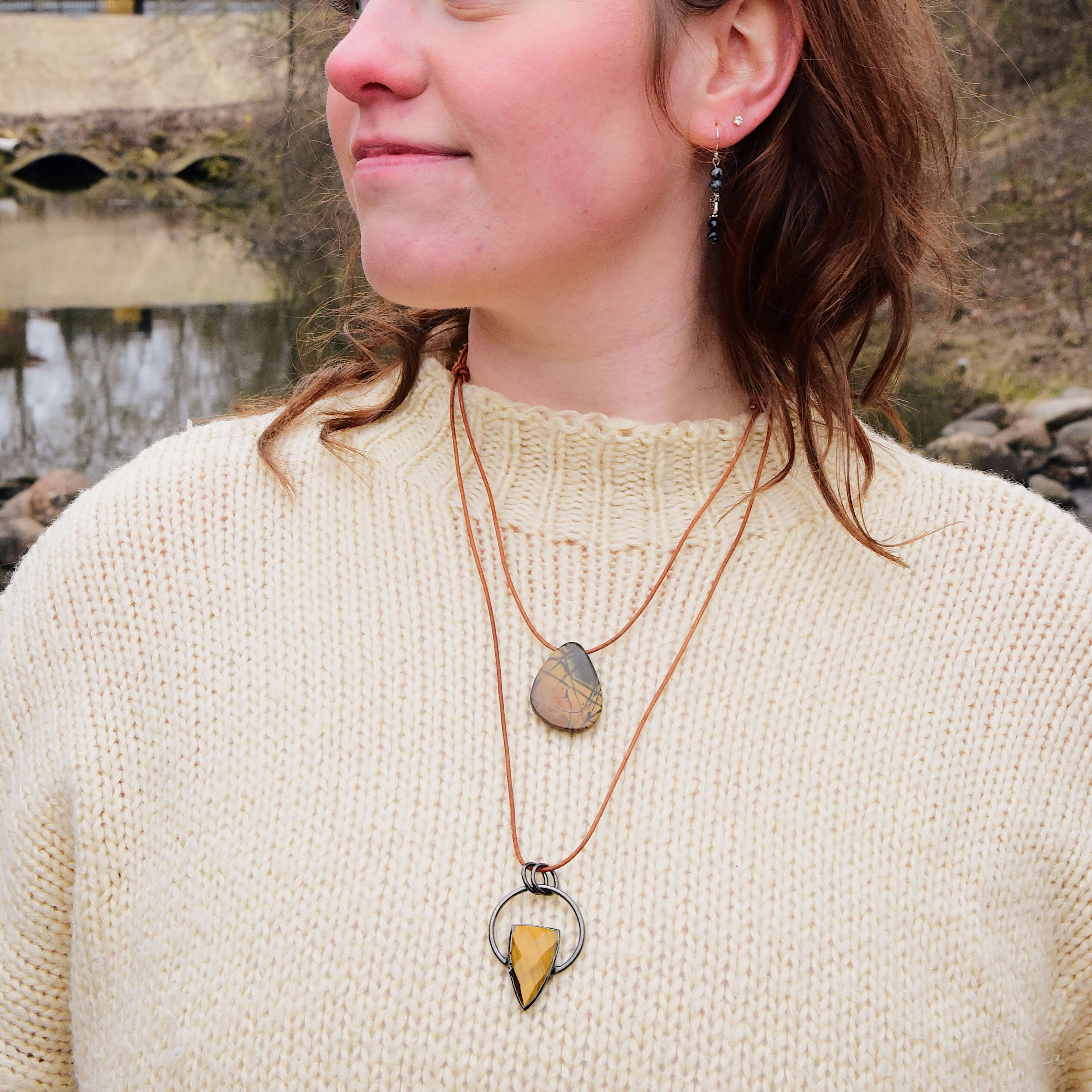 Tiger Eye Pendant Slide Knot Necklace This necklace is made with high-quality Tiger Eye gemstones which bring clarity and grounding energy to the wearer. Zodiac Signs: Leo and Capricorn. Chakras: Sacral, Solar Plexus, and Third Eye. Handmade with authenti