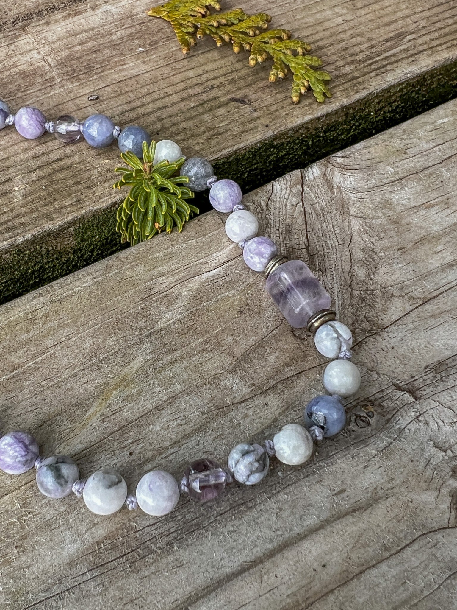 Fluorite marker bead and hand-knotted gemstones on the Morning Light Meditation Mala.