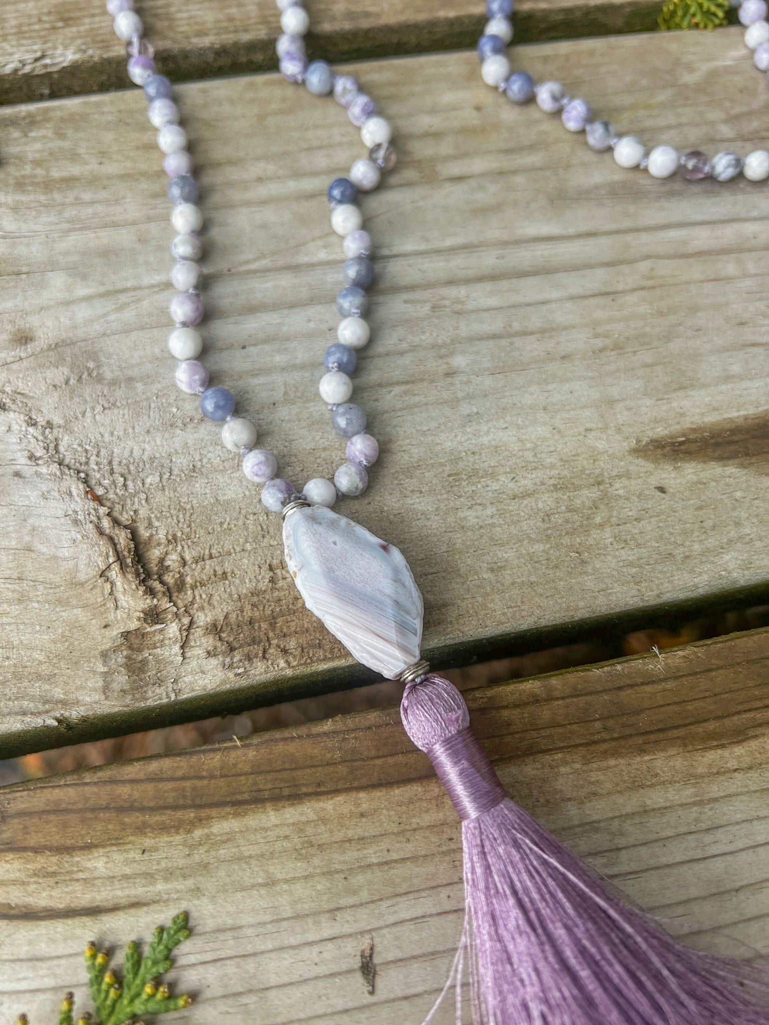 Raw Botswana Agate focal stone and silky lavender tassel on the handcrafted Morning Light Mala.