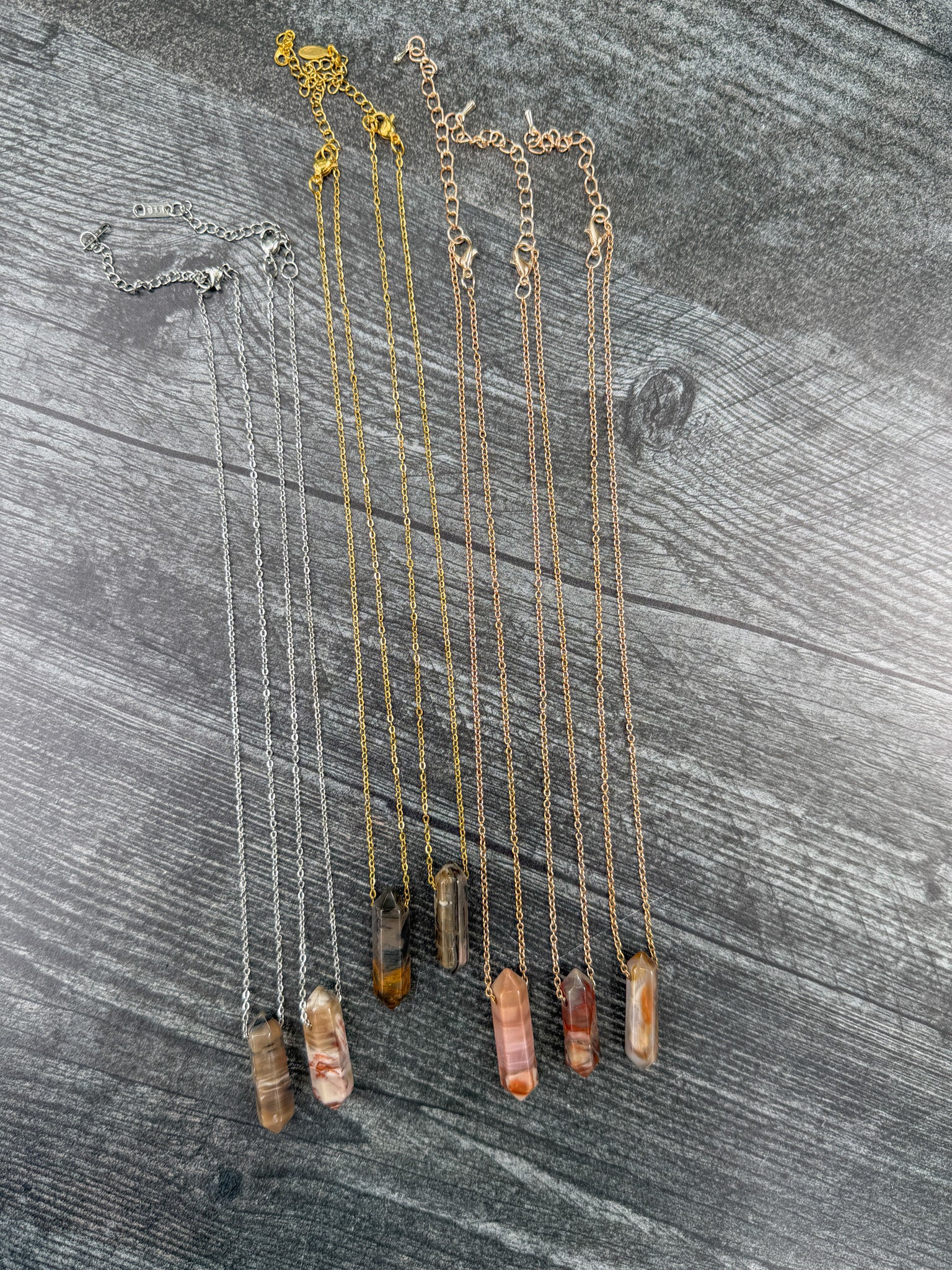 Earth Points Collection featuring seven unique Petrified Wood Agate Point Necklaces with gold, silver, and rose gold stainless steel chains at full length