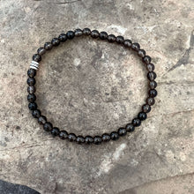 Load image into Gallery viewer, Smoky Quartz Bracelet This bracelet is made with high-quality Smoky Quartz gemstones which bring stress relief and protection from negativity to the wearer. Zodiac Signs: Scorpio, Sagittarius, and Capricorn. Chakras: Root and Solar Plexus. Handmade with a
