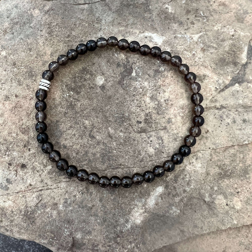 Smoky Quartz Bracelet This bracelet is made with high-quality Smoky Quartz gemstones which bring stress relief and protection from negativity to the wearer. Zodiac Signs: Scorpio, Sagittarius, and Capricorn. Chakras: Root and Solar Plexus. Handmade with a