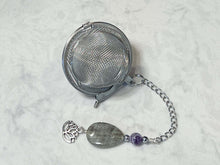 Load image into Gallery viewer, Amethyst and Labradorite Tea Strainer This tea strainer is made with a stainless steel tea ball, Chevron Amethyst, Labradorite, and Hematite beads. These stones offer clarity, transformation, and protection to the user.
