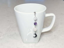 Load image into Gallery viewer, Amethyst and Quartz Tea Strainer This tea strainer is made with a stainless steel tea ball, Rose Quartz, Crystal Crackle Quartz, and Amethyst beads. These stones together bring the user mental clarity and universal love.
