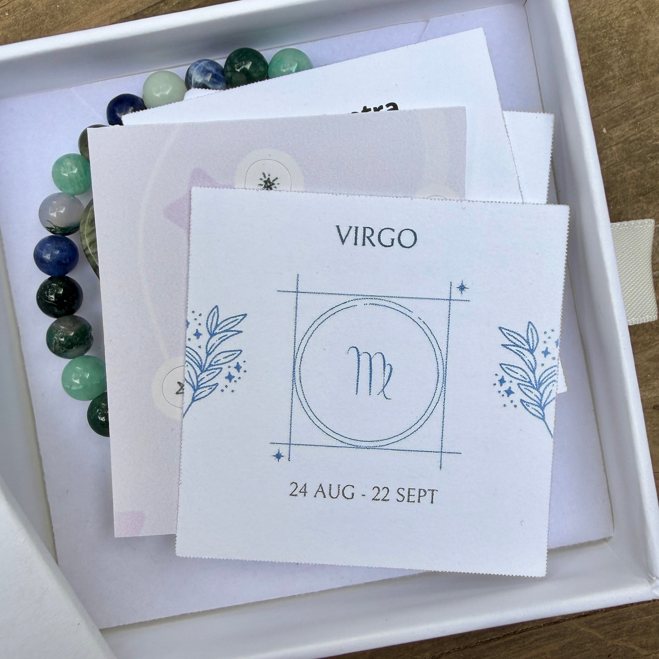 Virgo Zodiac Gift Box opened with illustrated Virgo card and gemstone bracelet inside