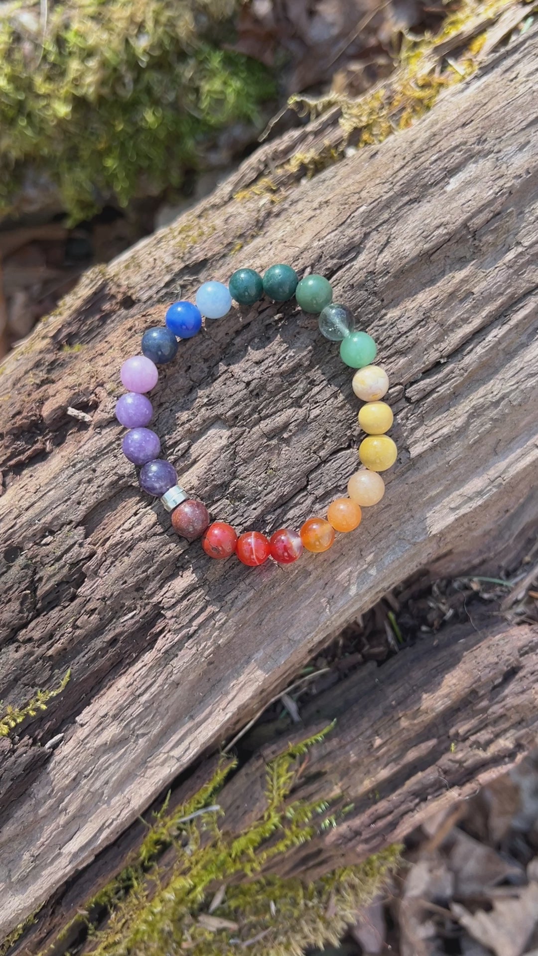 Video footage of the Rainbow Love Bracelet on a wood background