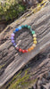 Video footage of the Rainbow Love Bracelet on a wood background