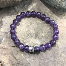 Load image into Gallery viewer, Amethyst Bead Bracelet This bracelet is made with high-quality Amethyst stones which bring serenity to the wearer. Zodiac: Aquarius. Chakras: Third Eye and Crown. Birthstone: February. Handmade with authentic crystals and gemstones in Minneapolis, MN.
