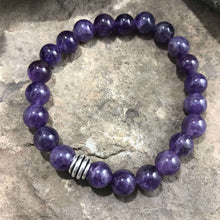 Load image into Gallery viewer, Amethyst Bead Bracelet This bracelet is made with high-quality Amethyst stones which bring serenity to the wearer. Zodiac: Aquarius. Chakras: Third Eye and Crown. Birthstone: February. Handmade with authentic crystals and gemstones in Minneapolis, MN.
