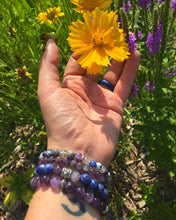 Load image into Gallery viewer, Model wearing Amethyst 8mm bracelet along with other stone bracelets with flowers 
