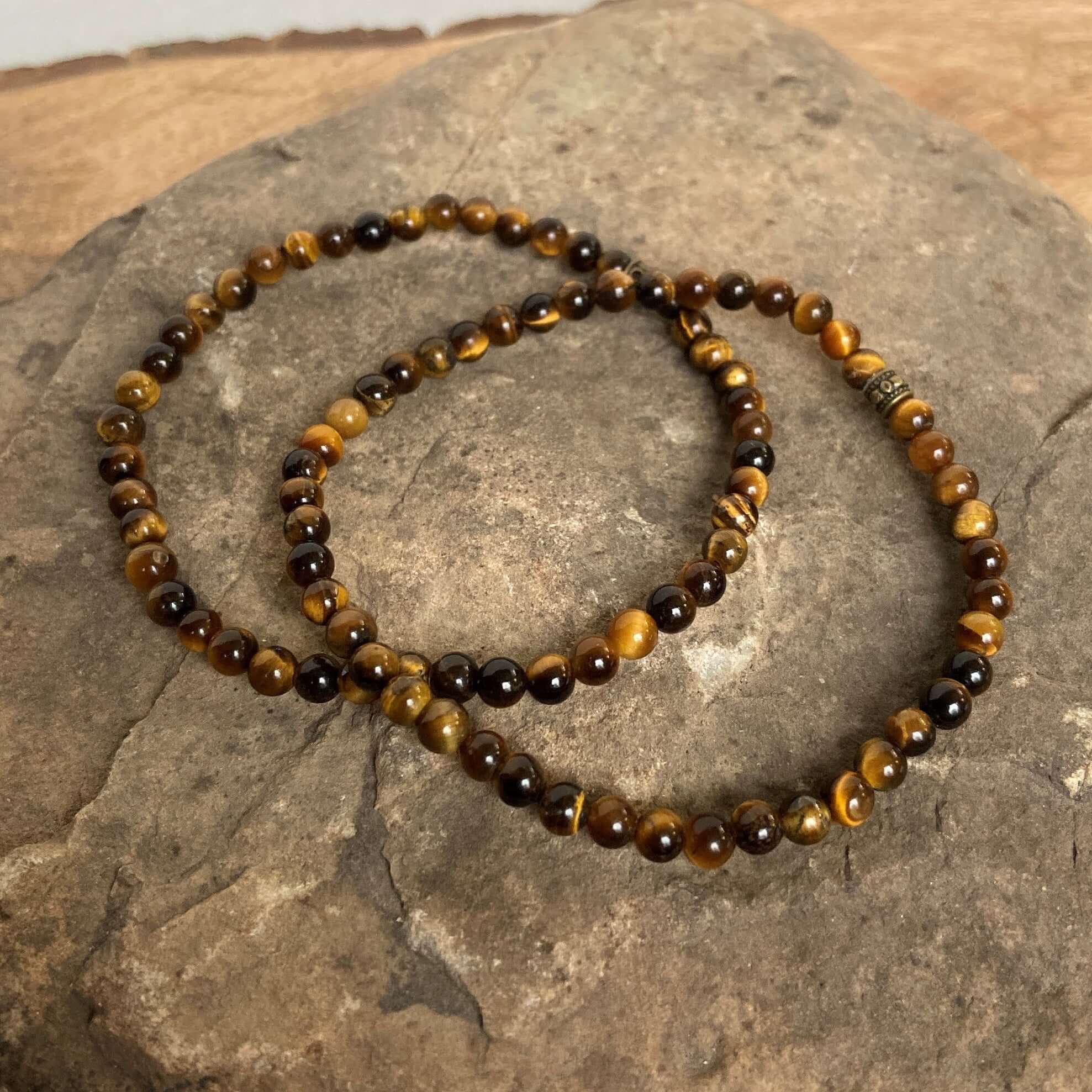 Tiger Eye Mini Bead Bracelet This bracelet is made with high-quality Tiger Eye gemstones which bring grounding and protective energy to the wearer. Zodiac Signs: Leo and Capricorn. Chakras: Sacral, Solar Plexus, and Third Eye. Handmade with authentic crys