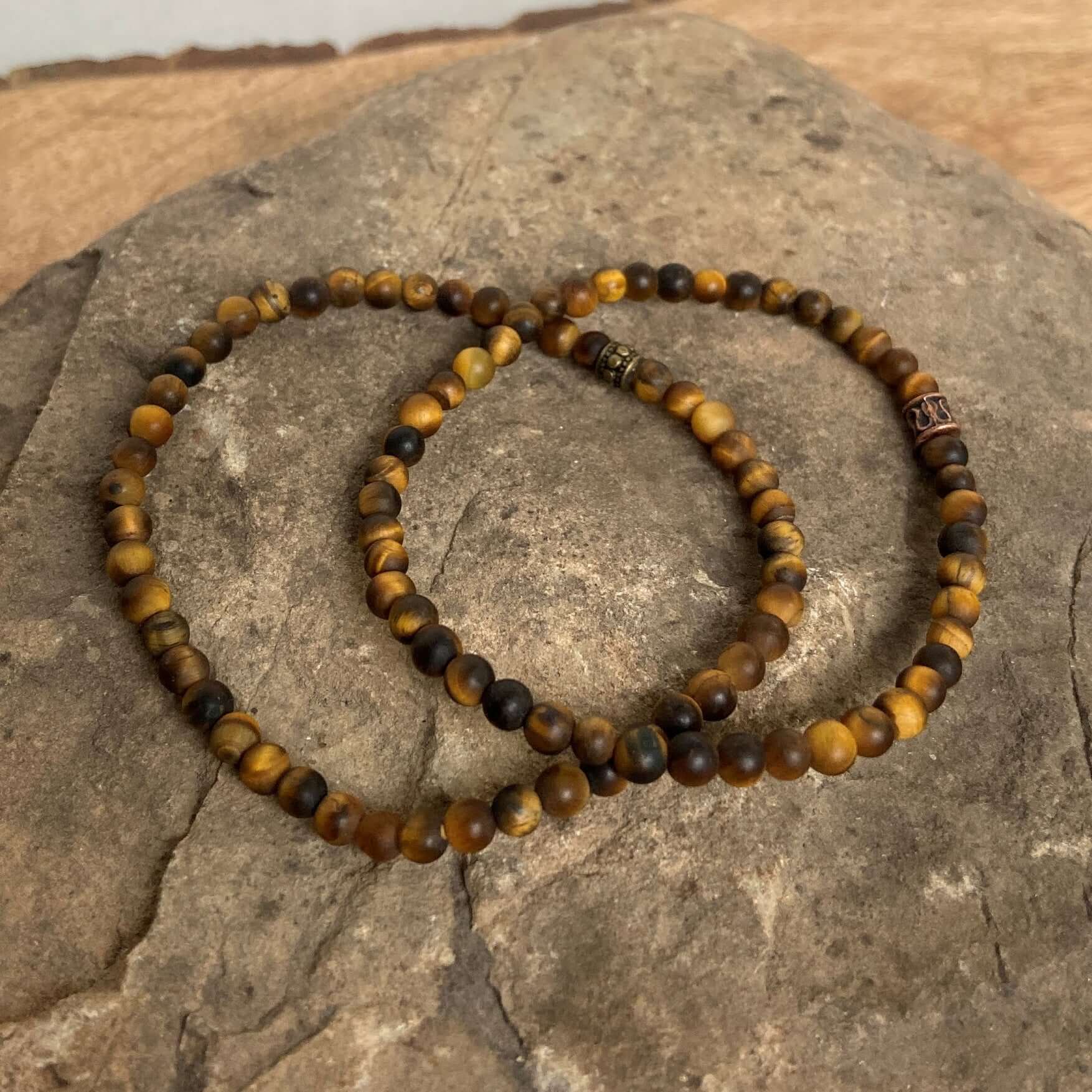 Tiger Eye Mini Bead Bracelet This bracelet is made with high-quality Tiger Eye gemstones which bring grounding and protective energy to the wearer. Zodiac Signs: Leo and Capricorn. Chakras: Sacral, Solar Plexus, and Third Eye. Handmade with authentic crys