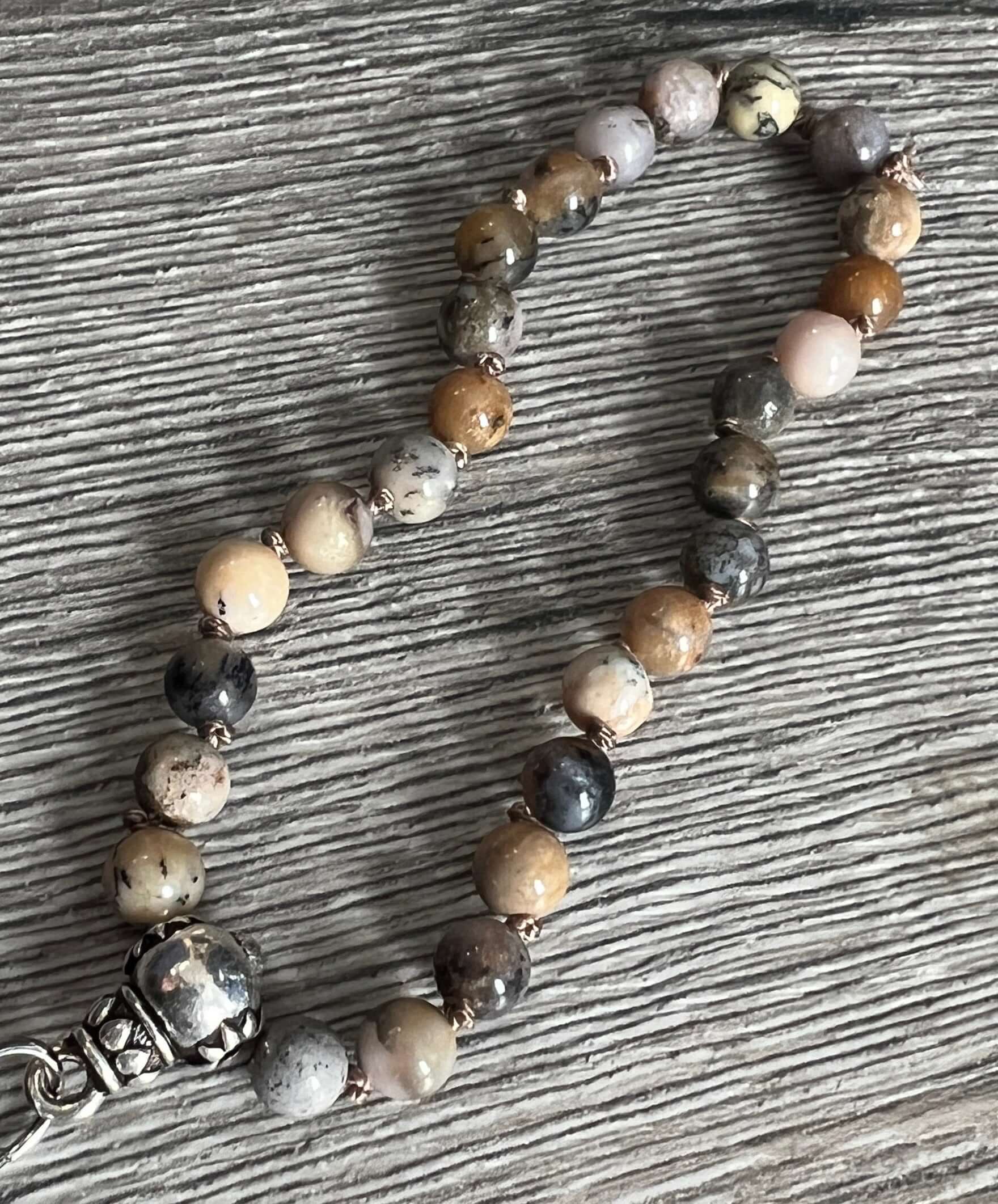 Black Moss Opal Wrist Mala This mala is made with authentic Black Moss Opal gemstones, which provide inspiration and prosperity for the wearer. Zodiac Signs: Scorpio & Libra. Chakras: Root. Handmade with authentic crystals and gemstones in Minneapolis, MN