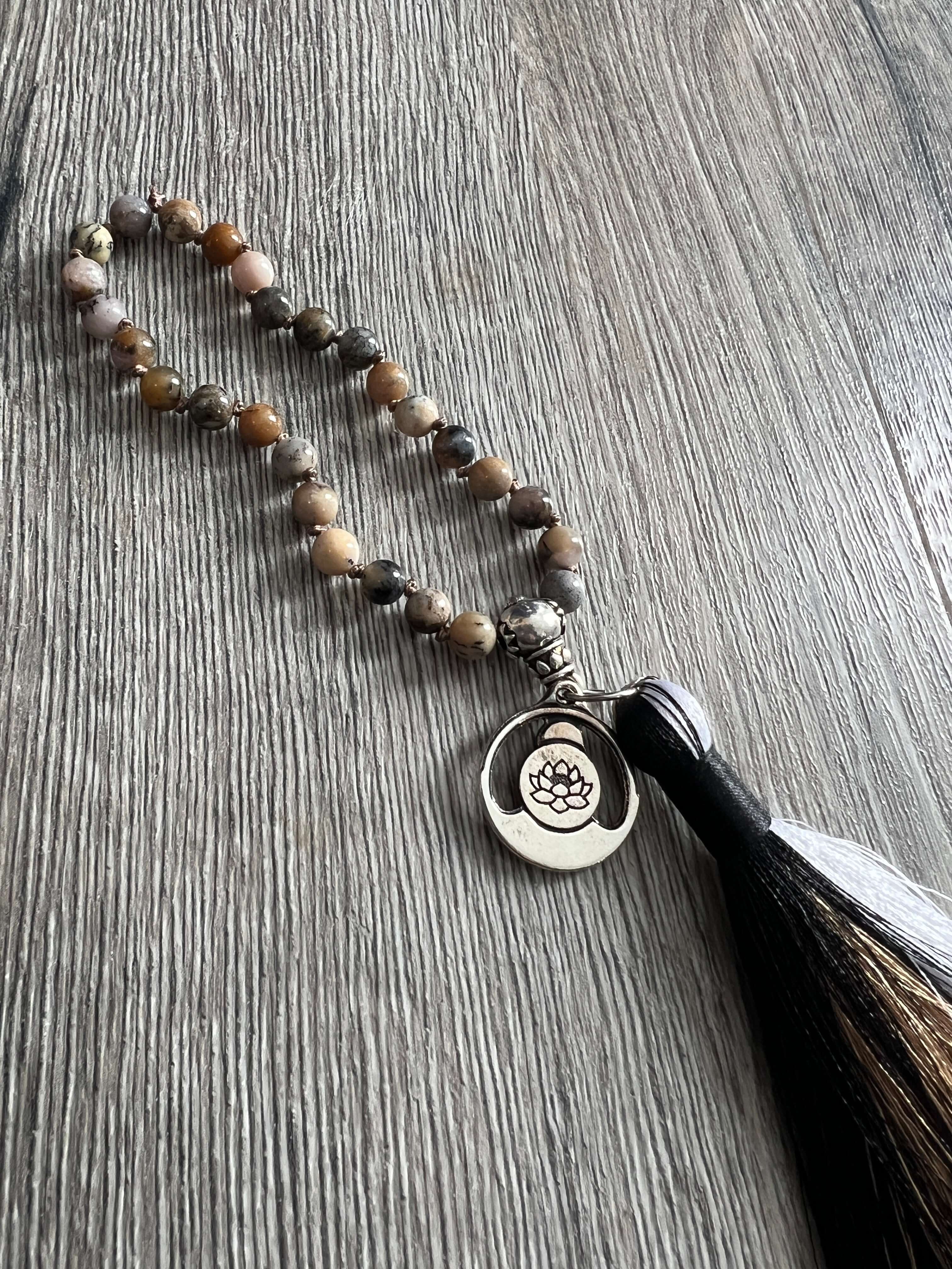 Black Moss Opal Wrist Mala This mala is made with authentic Black Moss Opal gemstones, which provide inspiration and prosperity for the wearer. Zodiac Signs: Scorpio & Libra. Chakras: Root. Handmade with authentic crystals and gemstones in Minneapolis, MN