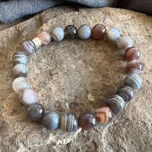 Load image into Gallery viewer, Botswana Agate Bracelet This bracelet is made from authentic Botswana Agate gemstones which bring comfort and hope to the wearer. Zodiac Signs: Gemini. Chakras: Root. Handmade with authentic crystals and gemstones in Minneapolis, MN.

