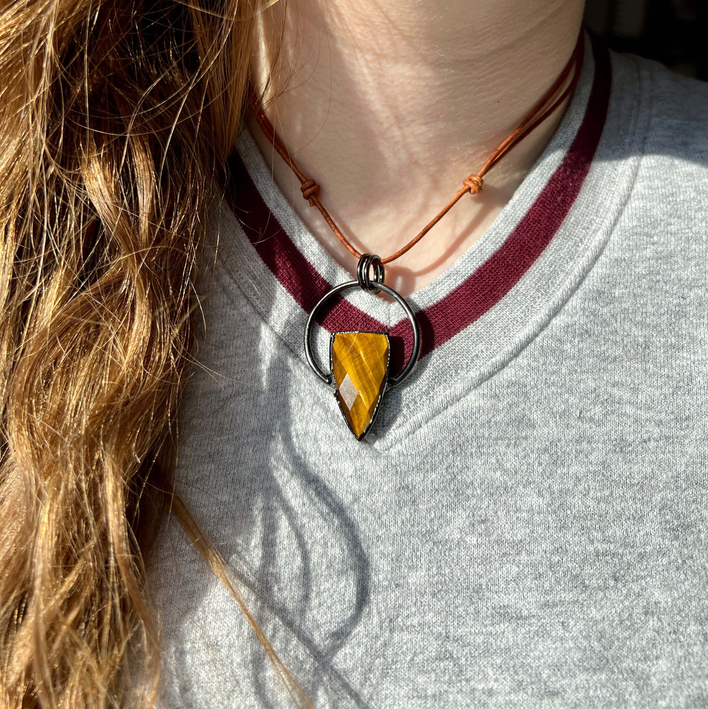 Tiger Eye Pendant Slide Knot Necklace This necklace is made with high-quality Tiger Eye gemstones which bring clarity and grounding energy to the wearer. Zodiac Signs: Leo and Capricorn. Chakras: Sacral, Solar Plexus, and Third Eye. Handmade with authenti