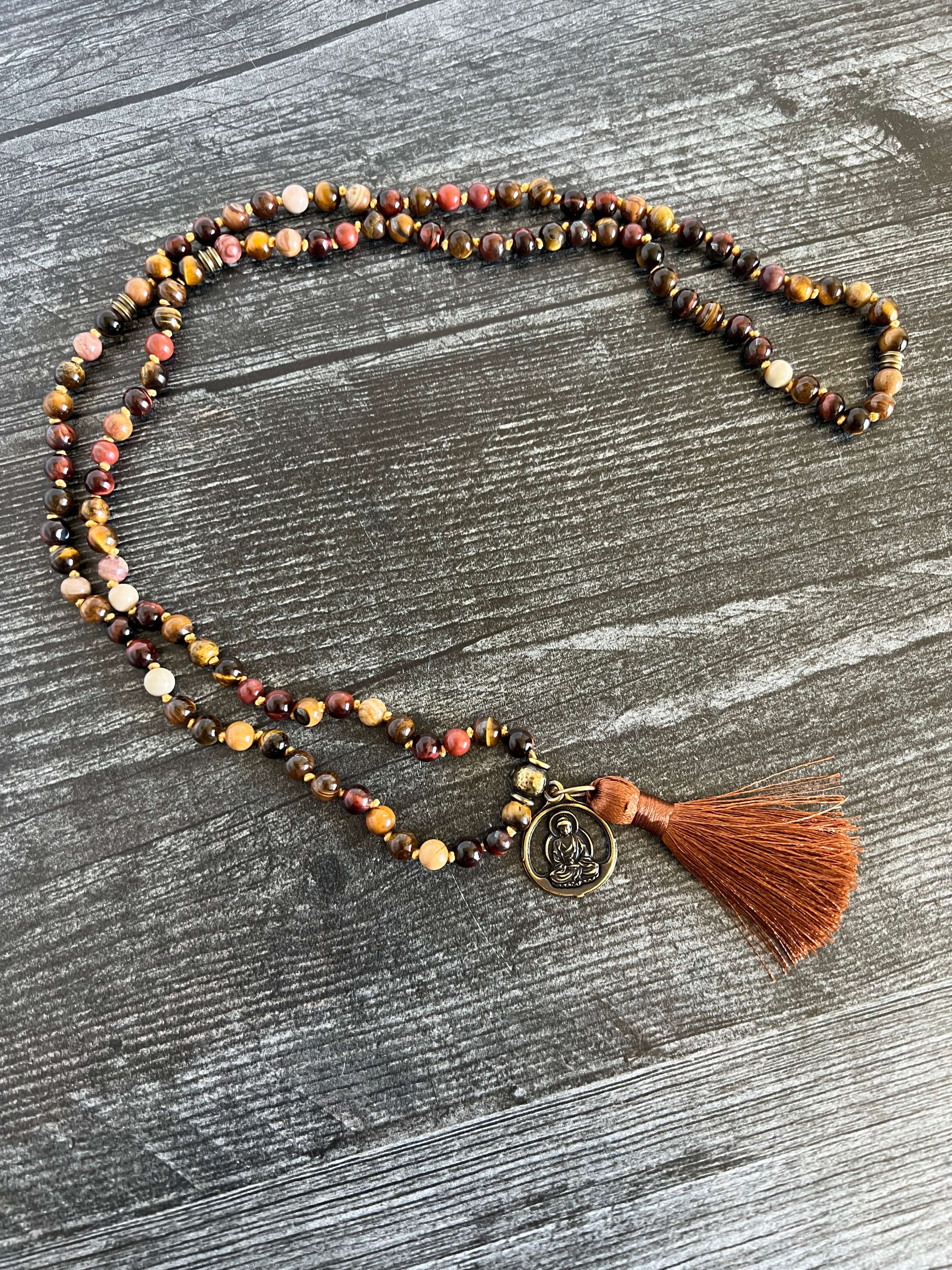 Tiger Eye Mala This mala is made with brown Tiger Eye, Red Tiger Eye, and Mookaite stones which bring a stable, grounding energy to the wearer. Due to the uniqueness of natural stone, your mala may look slightly different than the one pictured. Making you