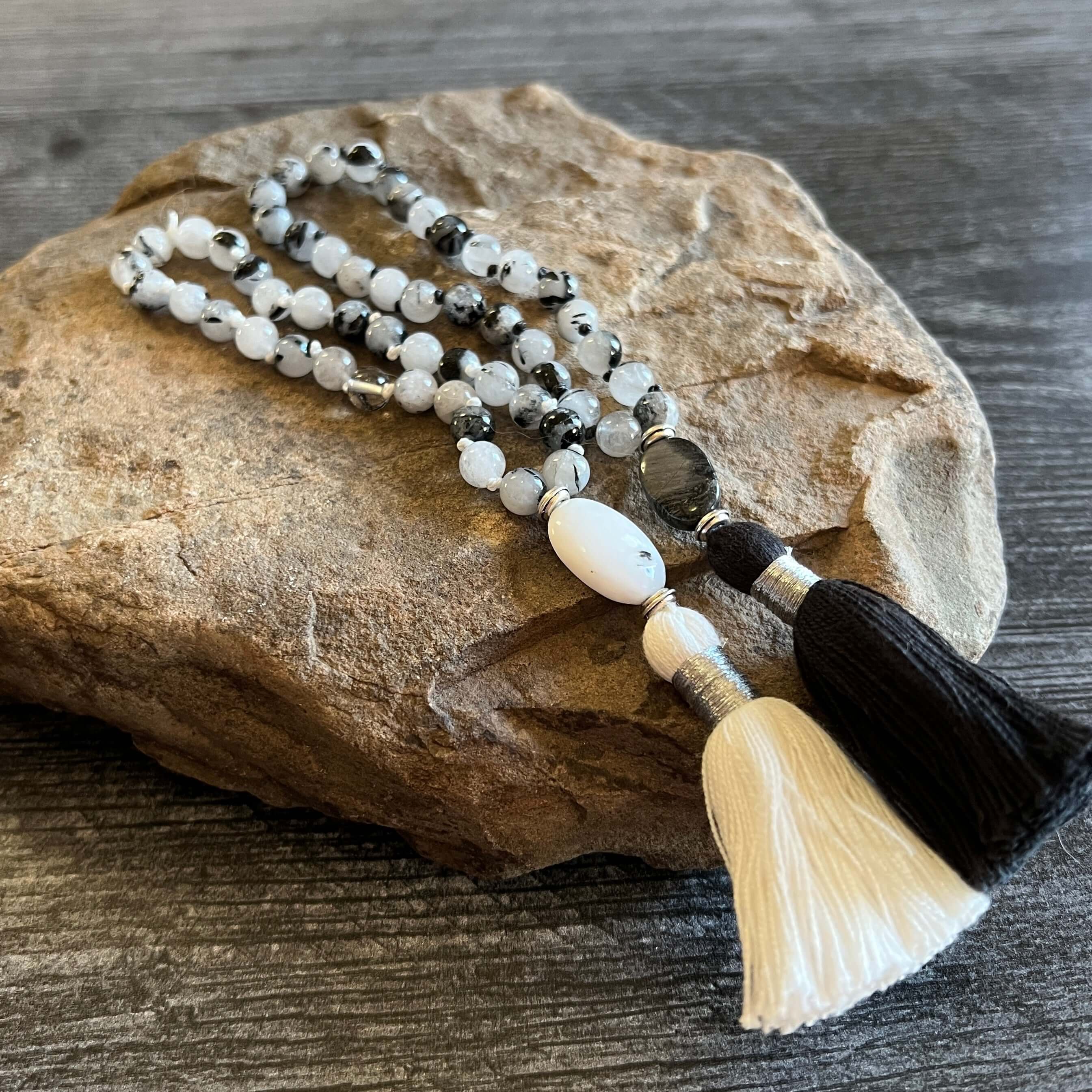 Tourmaline Quartz Wrist Mala These quarter malas are made with high-quality Tourmaline Quartz and Jasper gemstones which bring protection and tranquility to the wearer. Jasper is known as the “supreme nurturer.” Zodiac Signs: Libra, Scorpio, and Leo. Chak