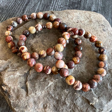 Load image into Gallery viewer, Bird&#39;s Eye Rhyolite Bracelet This bracelet is made with high-quality Bird&#39;s Eye Rhyolite stones which bring creativity &amp; confidence to the wearer. Zodiac Signs: Gemini, Sagittarius, and Aquarius. Chakras: Throat and Solar Plexus. Handmade with authentic c
