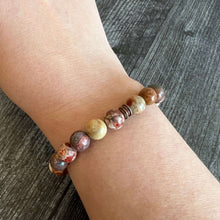 Load image into Gallery viewer, Bird&#39;s Eye Rhyolite Bracelet This bracelet is made with high-quality Bird&#39;s Eye Rhyolite stones which bring creativity &amp; confidence to the wearer. Zodiac Signs: Gemini, Sagittarius, and Aquarius. Chakras: Throat and Solar Plexus. Handmade with authentic c
