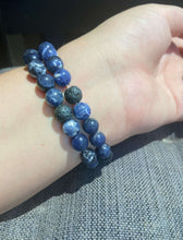 Load image into Gallery viewer, Sodalite Bracelet This bracelet is made with high-quality Sodalite gemstones which bring logic and intuition to the wearer. Zodiac Signs: Virgo and Sagittarius. Chakras: Throat and Third Eye. Handmade with authentic crystals &amp; gemstones in Minneapolis, MN
