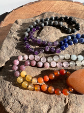 Load image into Gallery viewer, Sunset Mala This mala is made with authentic Carnelian, Yellow Jade, Lepidolite, Moonstone, Aquamarine, Sodalite, Amethyst, Larvikite, Red Aventurine, and Onyx gemstones which give the wearer a sense of being deeply rooted. Zodiac Signs: All. Chakras: All
