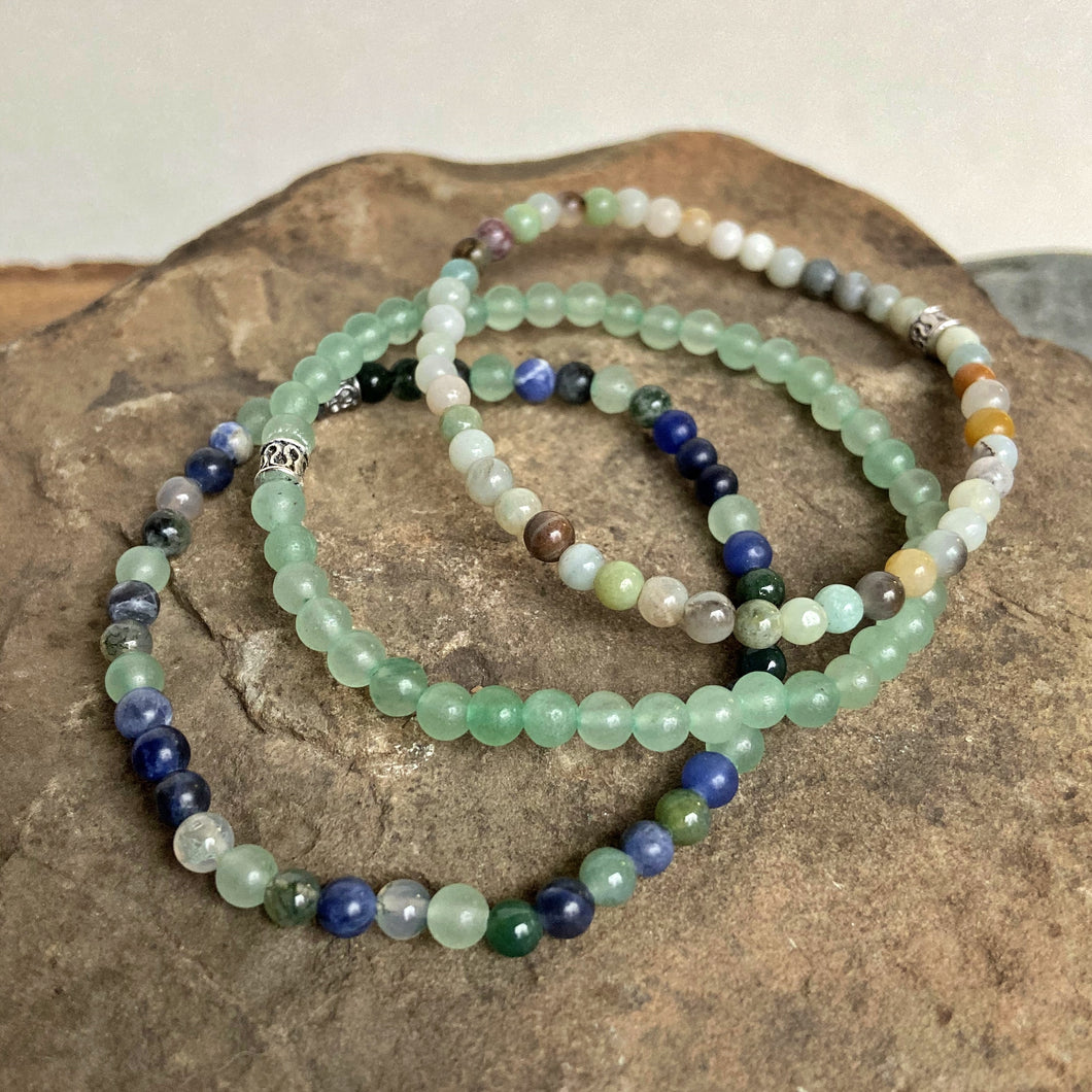 Picture of 3 bracelets included with bracelet set. Bottom one is made with sodalite, moss agate, and green aventurine stones. Second is green aventurine. Top is amazonite.