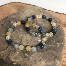 Load image into Gallery viewer, Oregon Coast Bead Bracelet This bracelet is made with high-quality Sodalite, Cloudy Quartz, and Yellow Jade gemstones which bring self-confidence, focus, and creativity to the wearer. Zodiac Signs: Sagittarius, Aries &amp; Pisces. Chakras: Throat, Third Eye,
