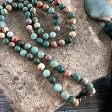 Load image into Gallery viewer, Forest Walk Mala This mala is made with high-quality Agate and Jasper gemstones which bring strength and tranquility to the wearer. Zodiac Signs: Leo, Gemini, Aries, Scorpio, and Virgo. Chakras: Third Eye, Root, Crown, and Heart. Handmade with authentic c
