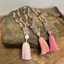 Load image into Gallery viewer, Rose Quartz Wrist Mala These quarter malas are made with high-quality Rose Quartz, Lepidolite, and Moonstone beads which bring love, release, and inspiration to the wearer. Zodiac Signs: Libra and Taurus. Chakras: Third Eye, Crown, Heart and Sacral. Handm

