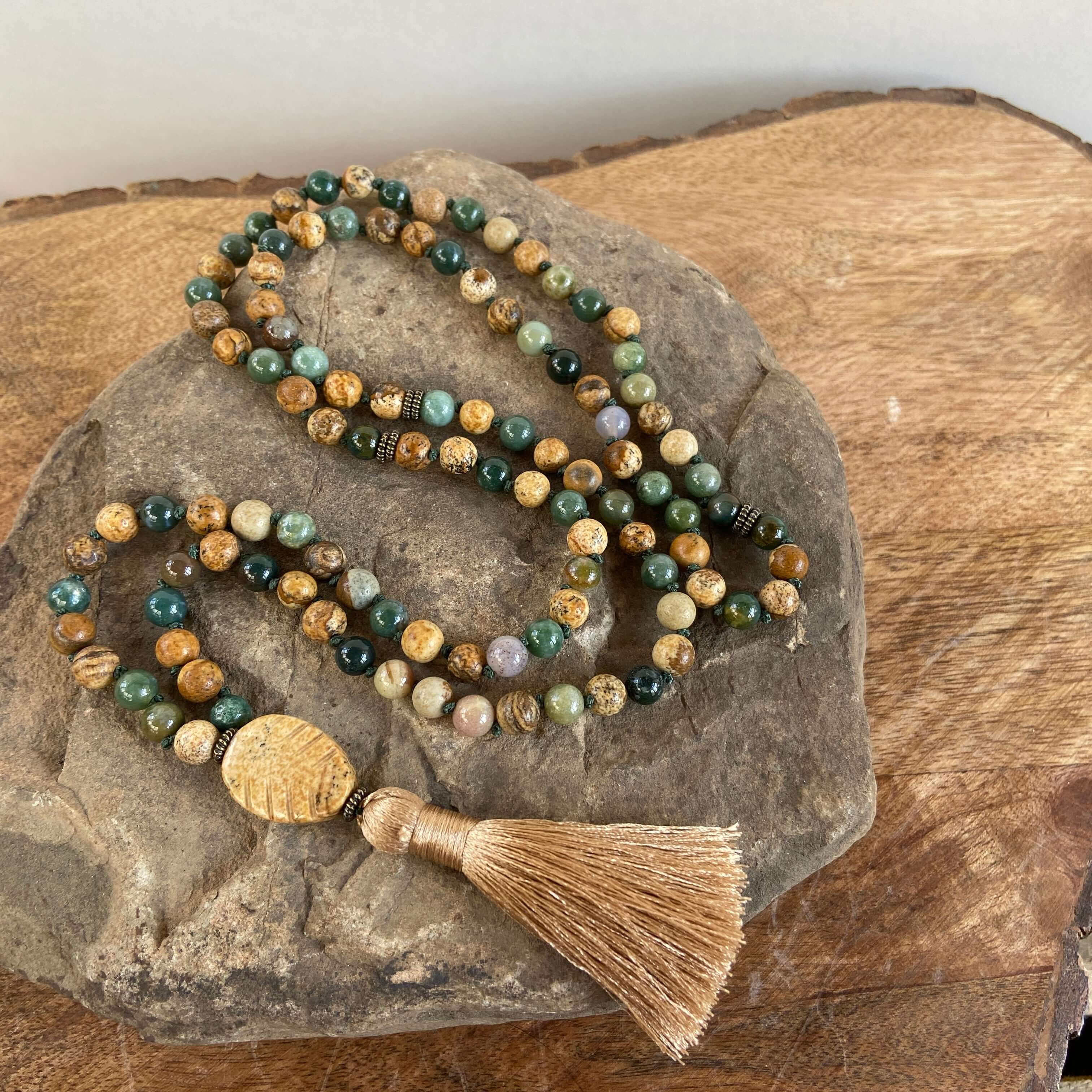 Tree Mala While creating these malas, I kept imaging the look of trees along the north shore of Lake Superior. It is made with 6mm sized Moss Agate and Picture Jasper stones, along with a Picture Jasper guru bead carved to look like a leaf. and brown silk