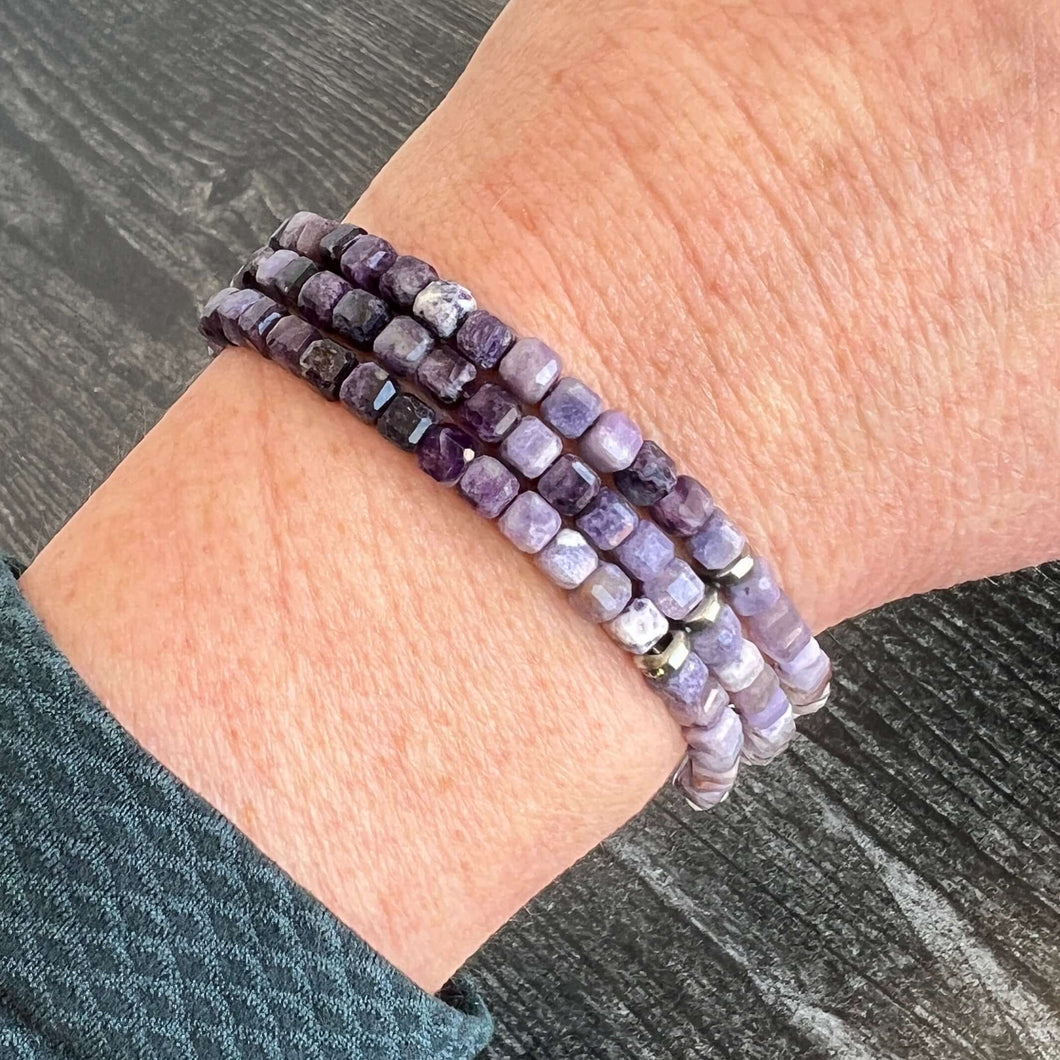 Silky Fluorite Stacked Bracelet Silky Fluorite is a rare form of Fluorite with a silky opaque luster. The luster appearance is from quartz inclusions. These quartz inclusions influence the passing of light through the mineral thus creating a silky, fibrou